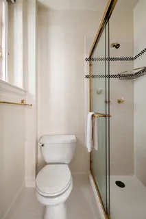 a bathroom with a toilet and a shower