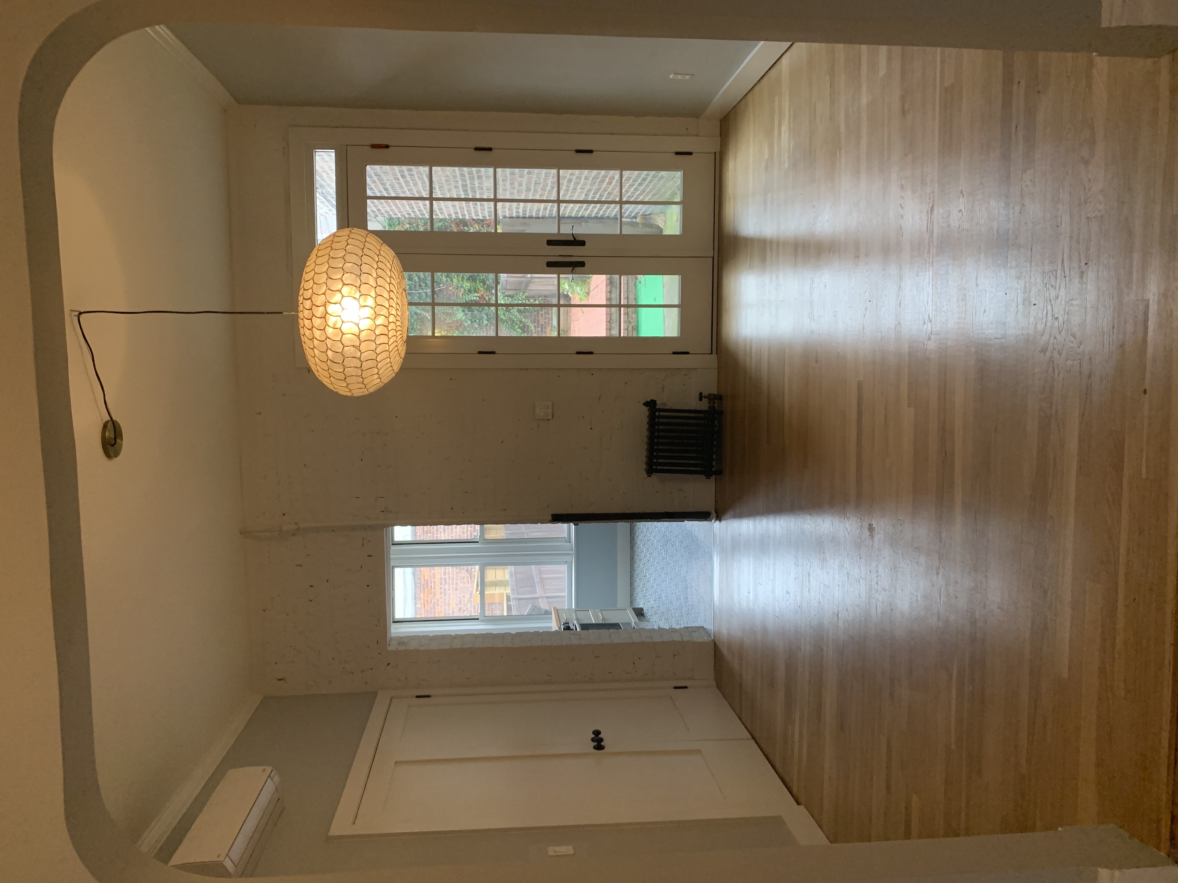 285 Empire Boulevard Brooklyn, NY 11225 - Photo 2 of 7 an empty room with wooden floor and windows