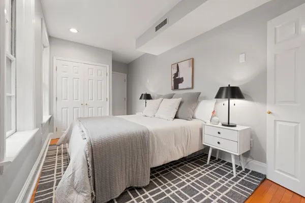 a bedroom with a bed and a window