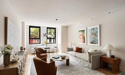 a living room with furniture and large windows