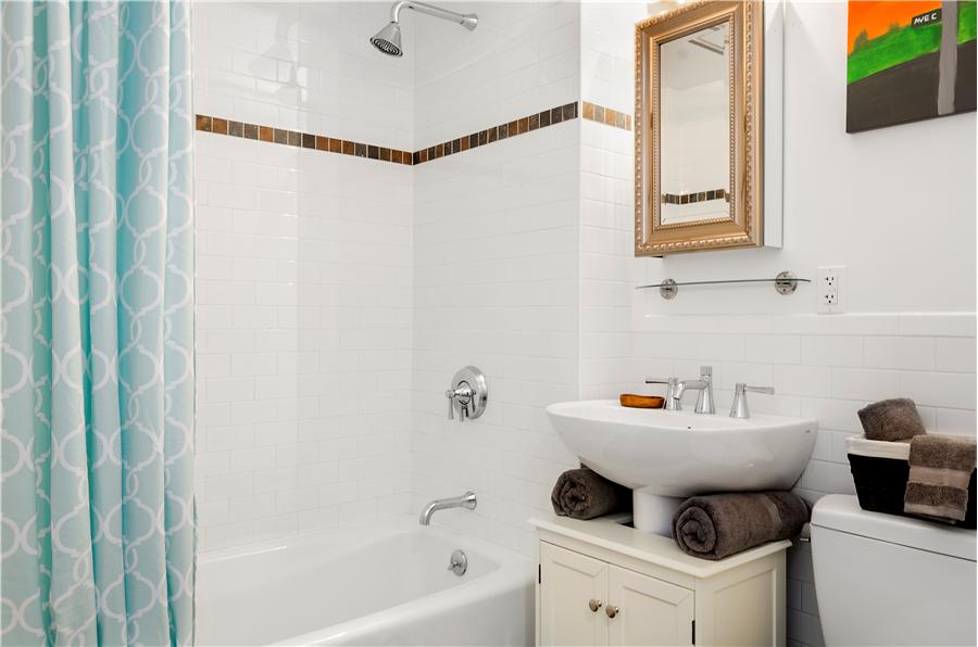 189 Avenue C, Unit 2C Manhattan, NY 10009 - Photo 6 of 10 a bathroom with a sink toilet and shower