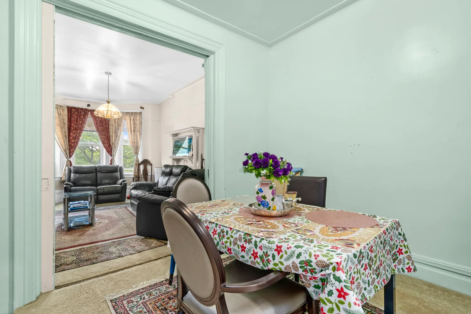 a view of a dining room with furniture and a potted plant