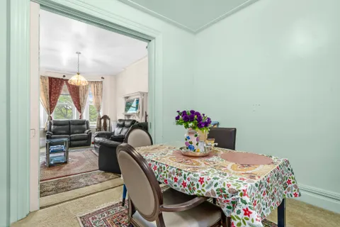 a view of a dining room with furniture and a potted plant