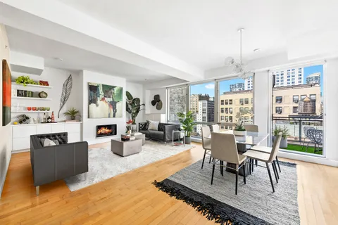 a living room with fireplace furniture and a wooden floor