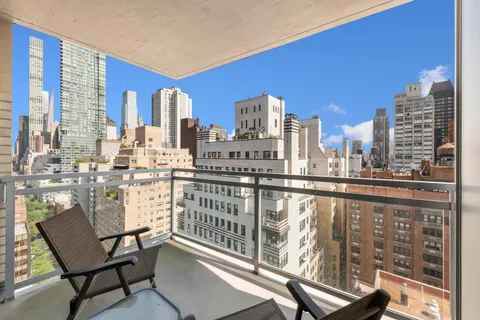 a view of a balcony with chairs