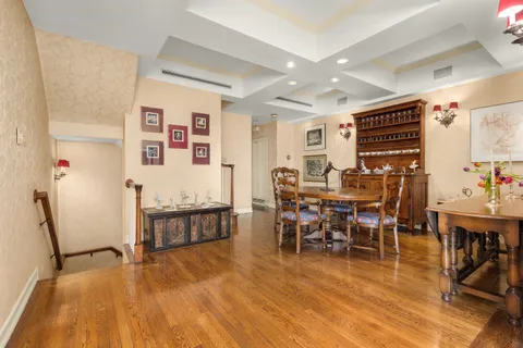 a kitchen with stainless steel appliances granite countertop a stove a sink dishwasher and microwave with wooden floor