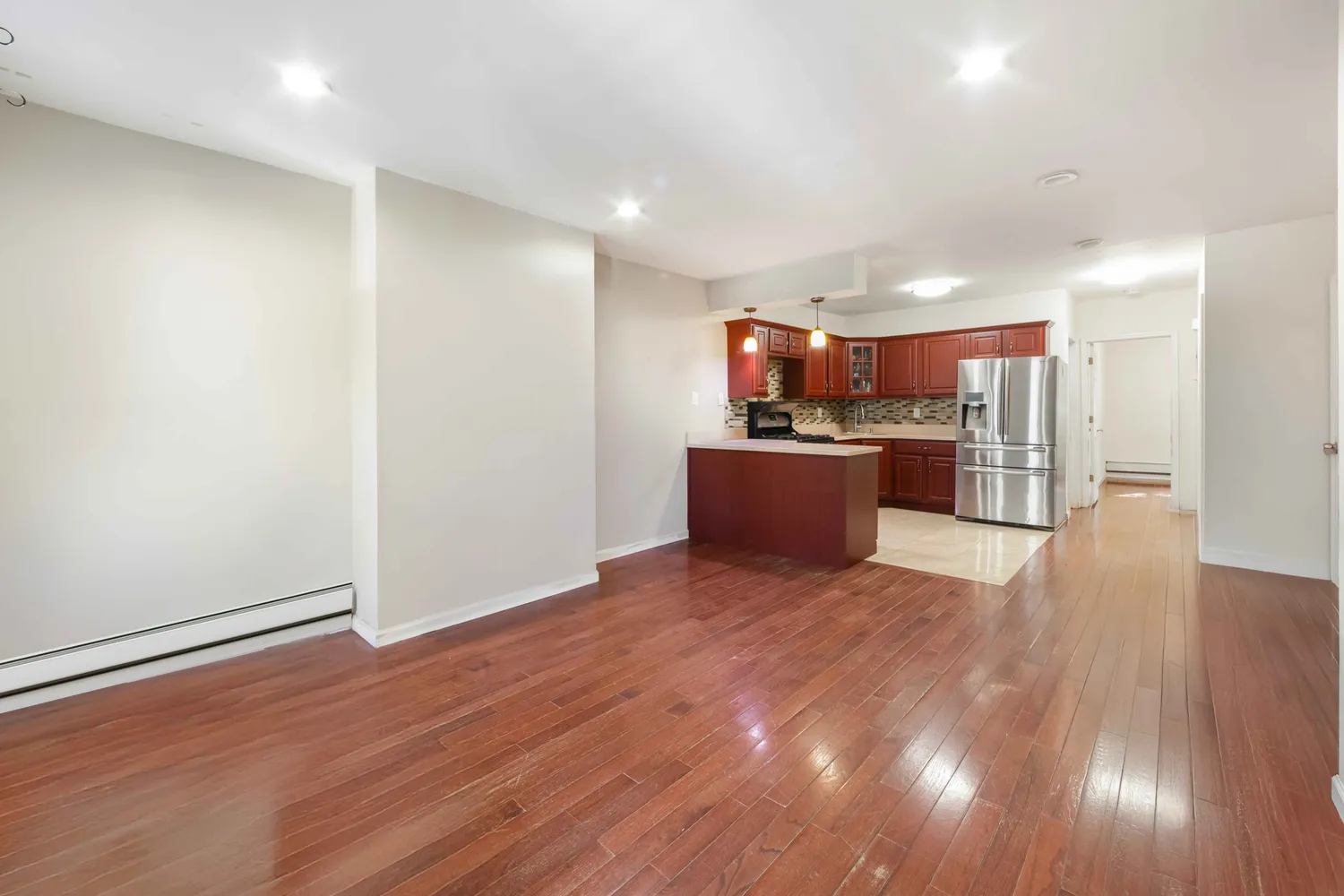 a view of a kitchen with a sink and a refrigerator