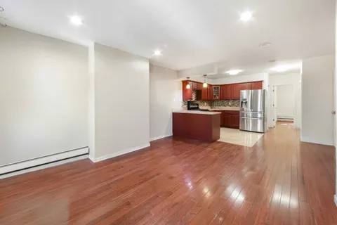 a view of a kitchen with a sink and a refrigerator
