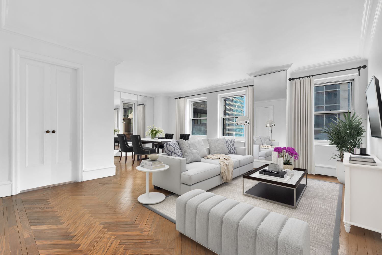 465 Park Avenue, Unit 26C Manhattan, NY 10022 - Photo 1 of 10 a living room with furniture and a large window