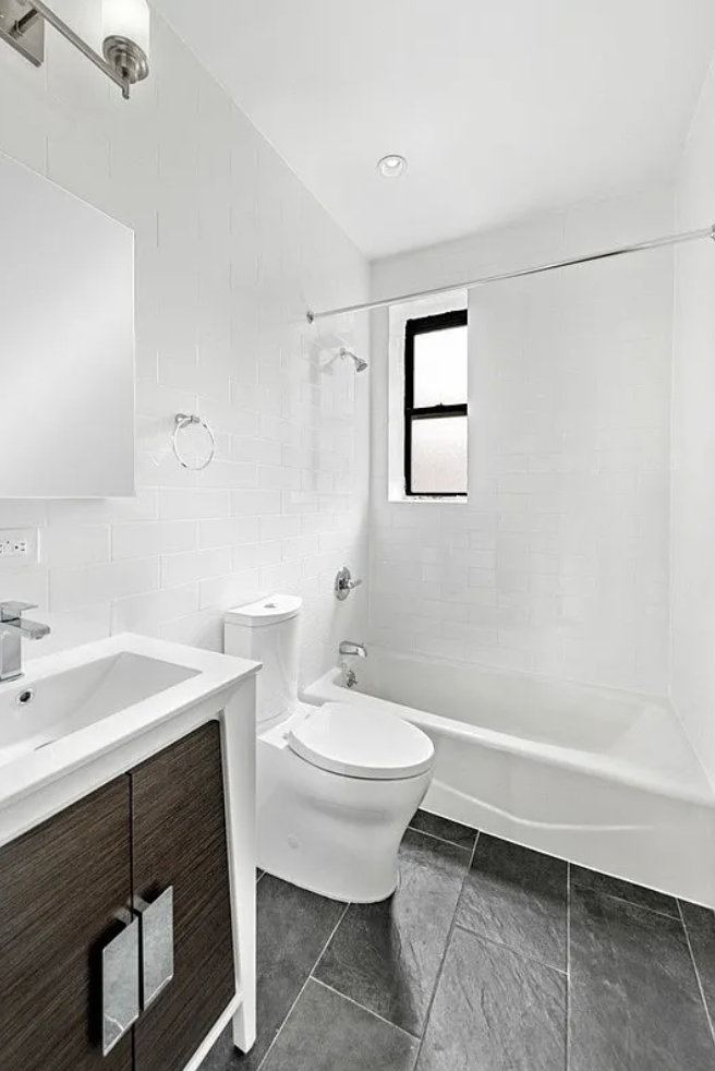 601 Crown Street, Unit C3 Brooklyn, NY 11213 - Photo 6 of 9 a bathroom with a sink toilet and vanity
