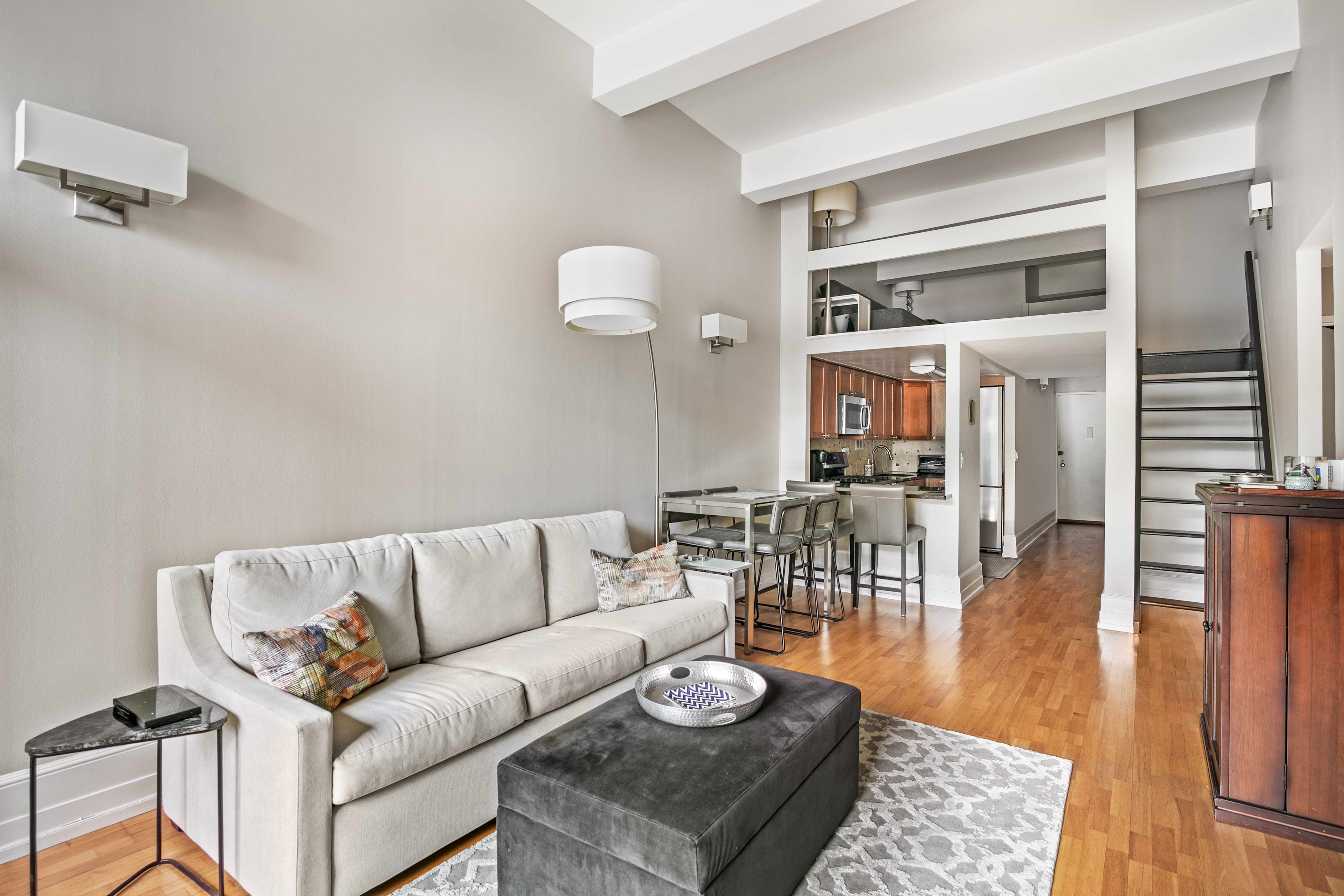 a living room with furniture wooden floor and a rug