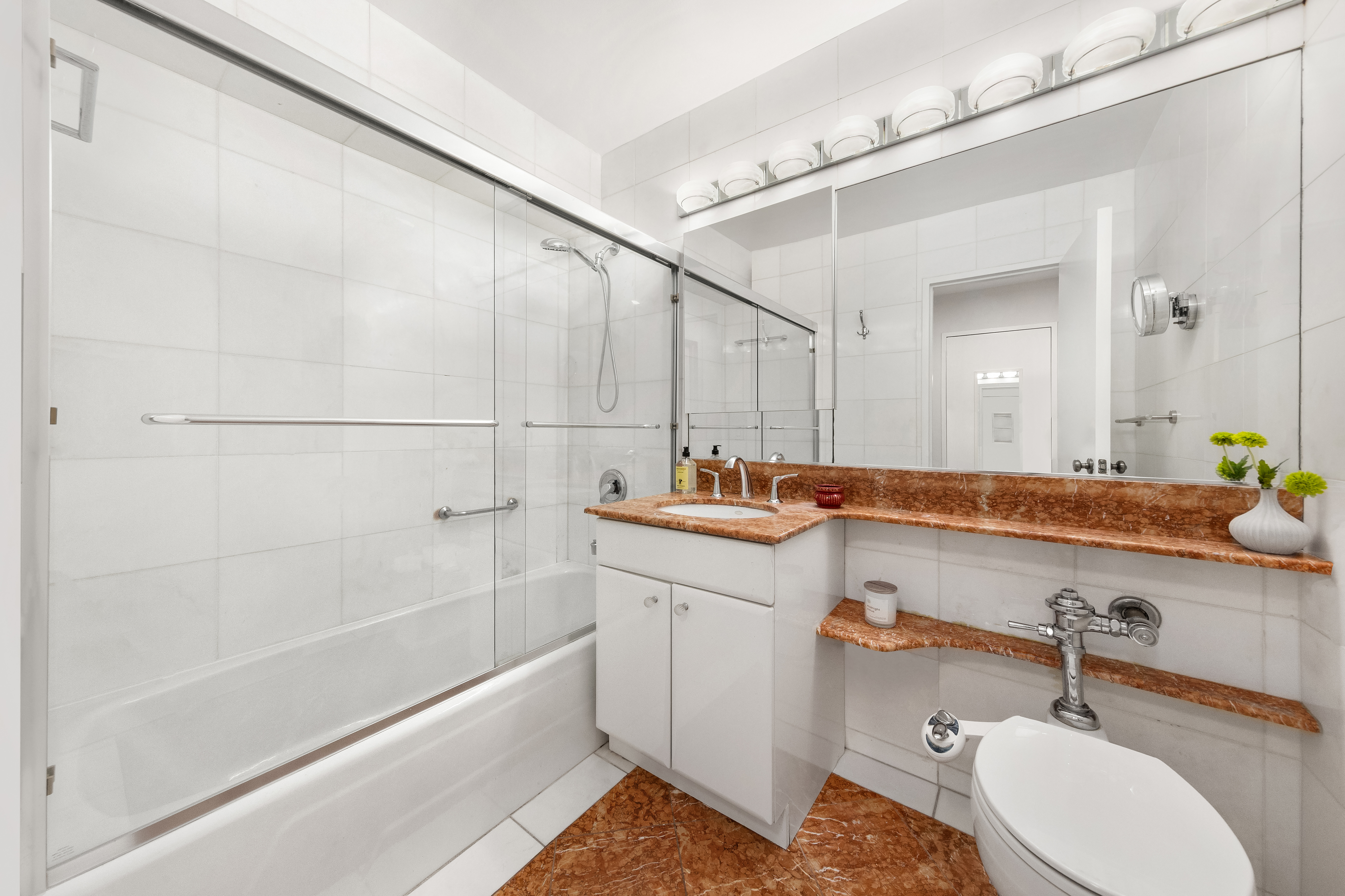 530 East 72nd Street, Unit 4F Manhattan, NY 10021 - Photo 10 of 23 a bathroom with a sink and a mirror a bathtub