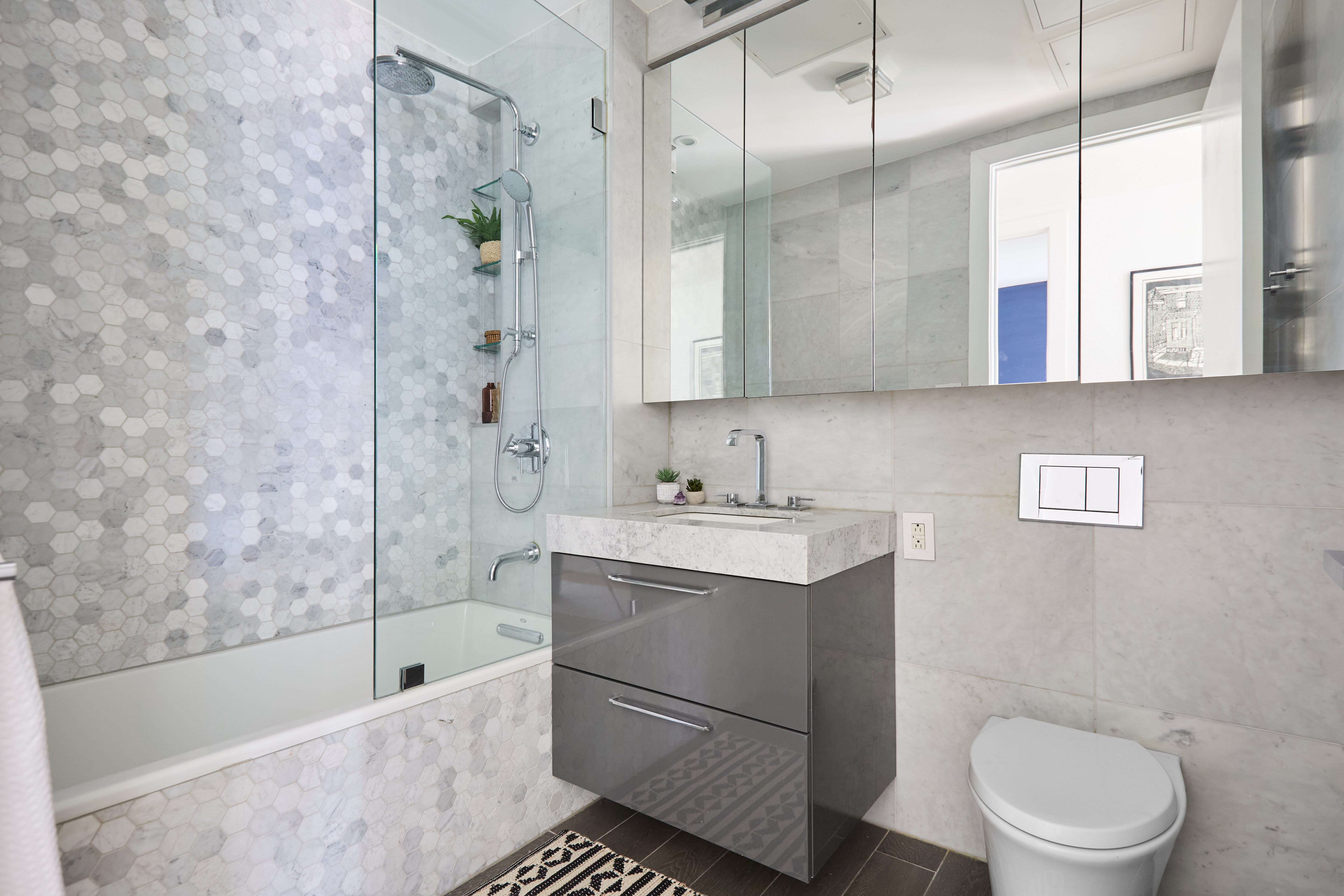 47 Bridge Street, Unit 3DD Brooklyn, NY 11201 - Photo 12 of 24 a bathroom with a sink a toilet and shower