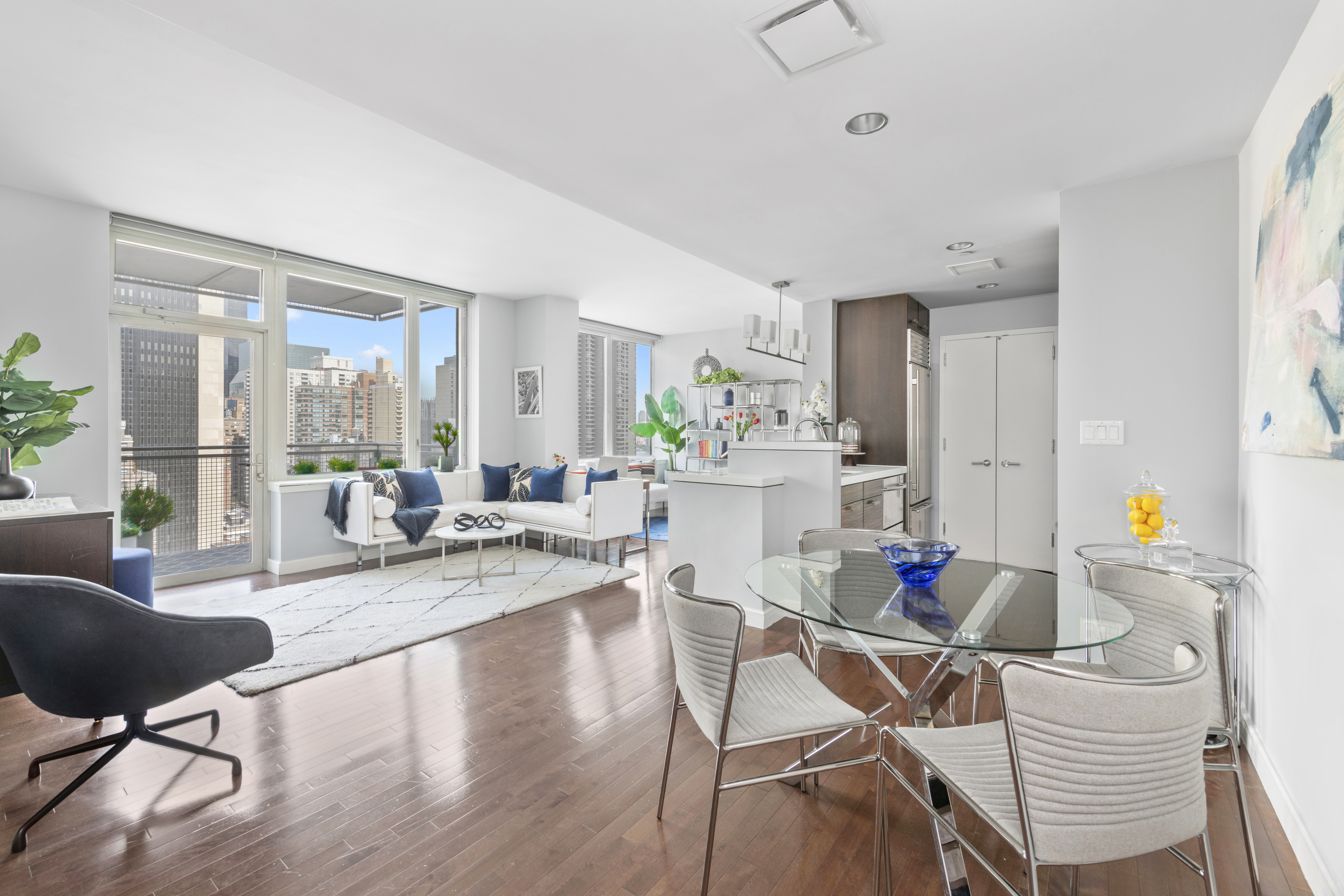 225 East 34th Street, Unit 21I Manhattan, NY 10016 - Photo 2 of 24 a living room with dining room and wooden floor
