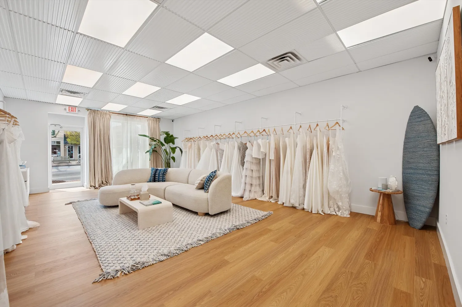 a living room with lots of furniture and view of kitchen