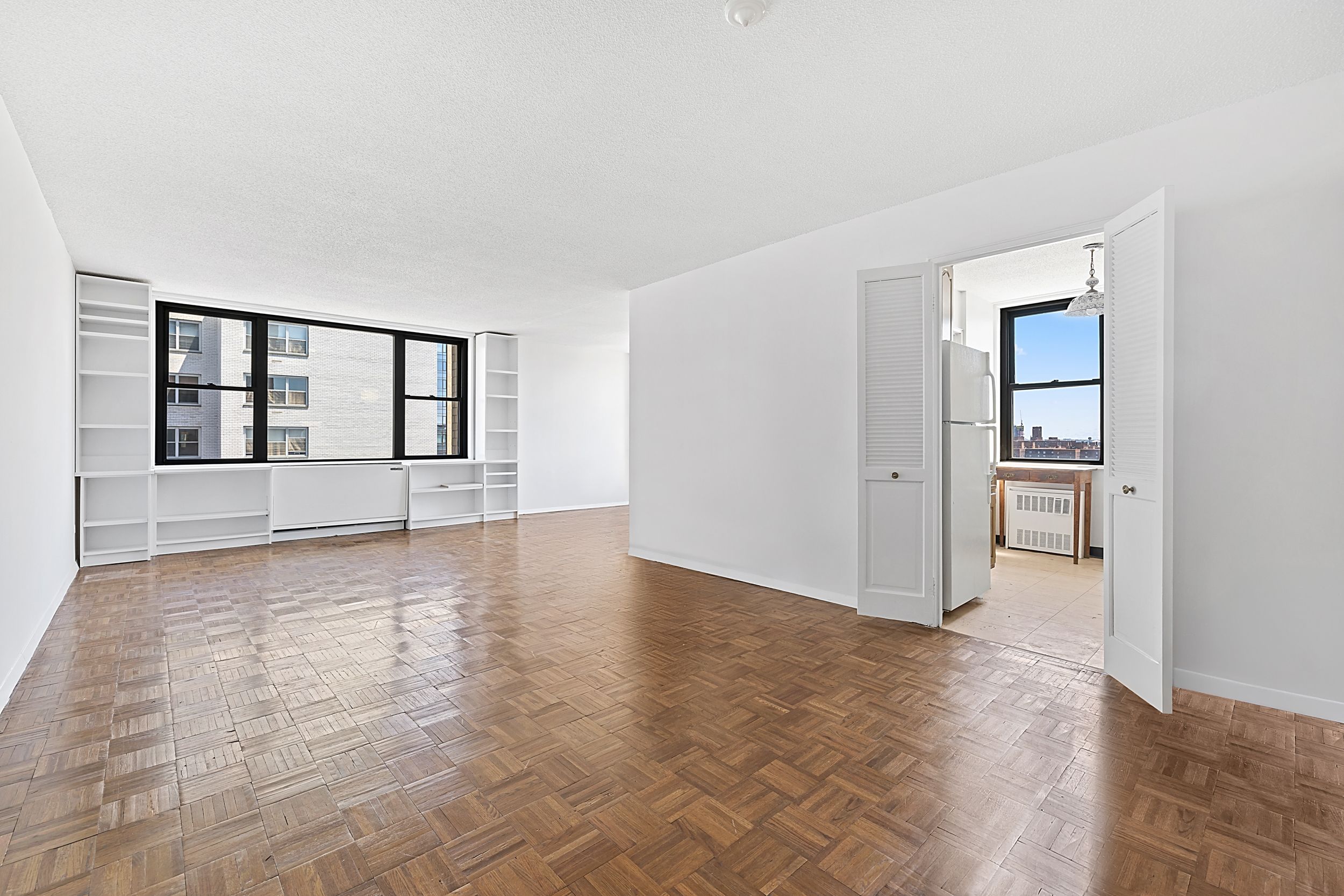 201 East 17th Street, Unit 15H Manhattan, NY 10003 - Photo 11 of 24 wooden floor in an empty room with a window