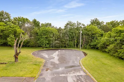 a view of a swimming pool with a yard