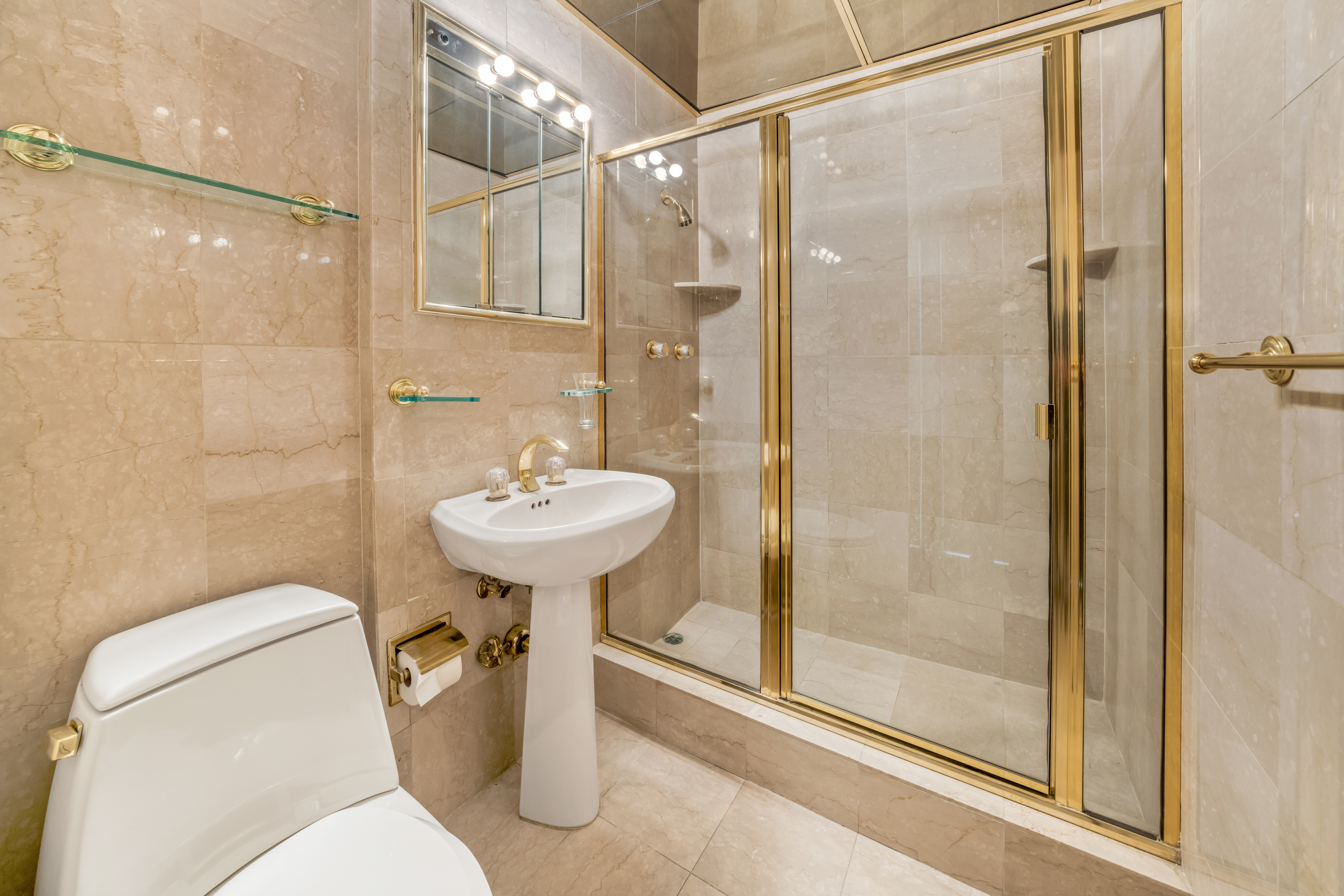 50 Sutton Place South, Unit 21L Manhattan, NY 10022 - Photo 5 of 12 a bathroom with a sink toilet and shower