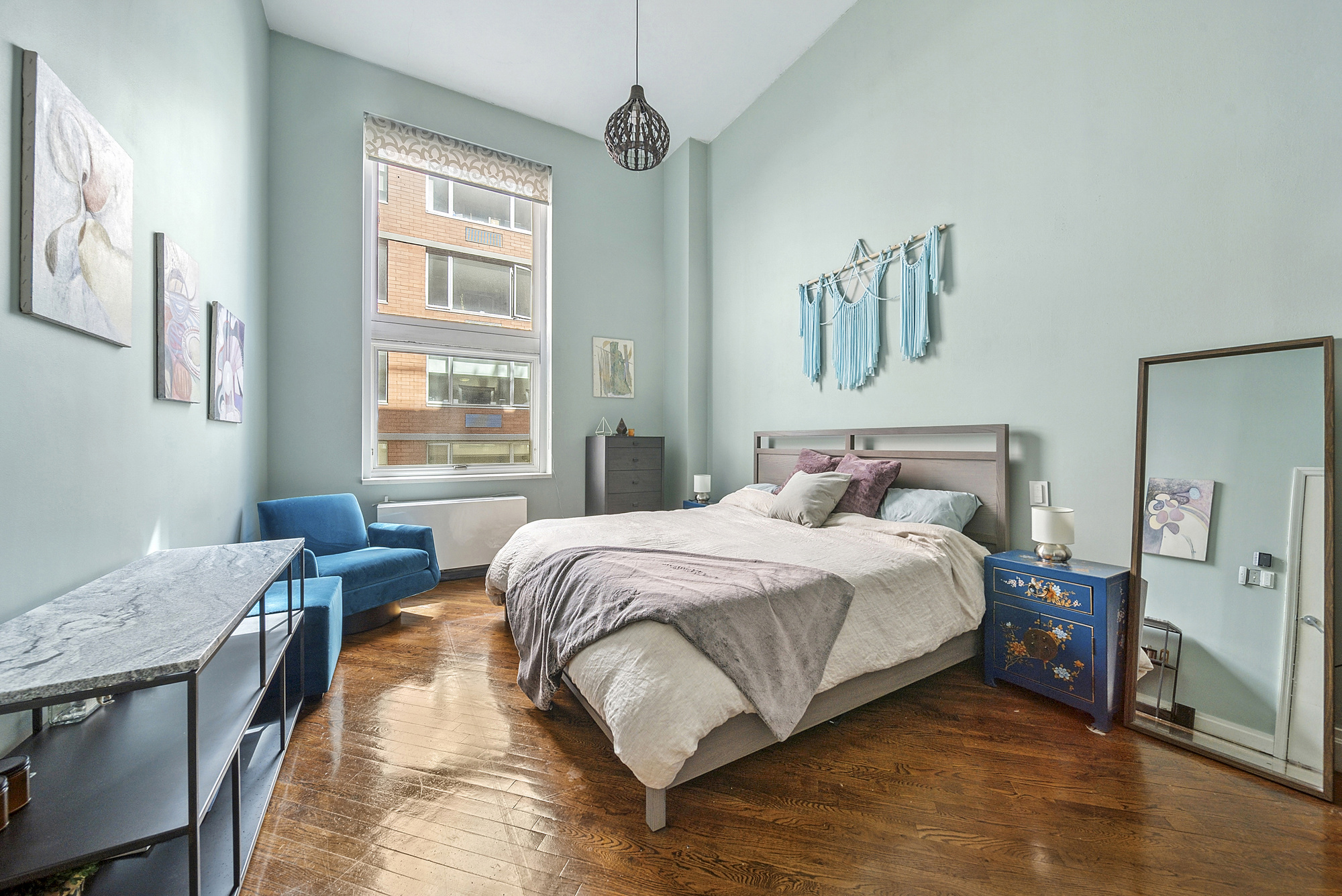 121 West 20th Street, Unit 3C Manhattan, NY 10011 - Photo 5 of 10 a bedroom with a bed and a table in it