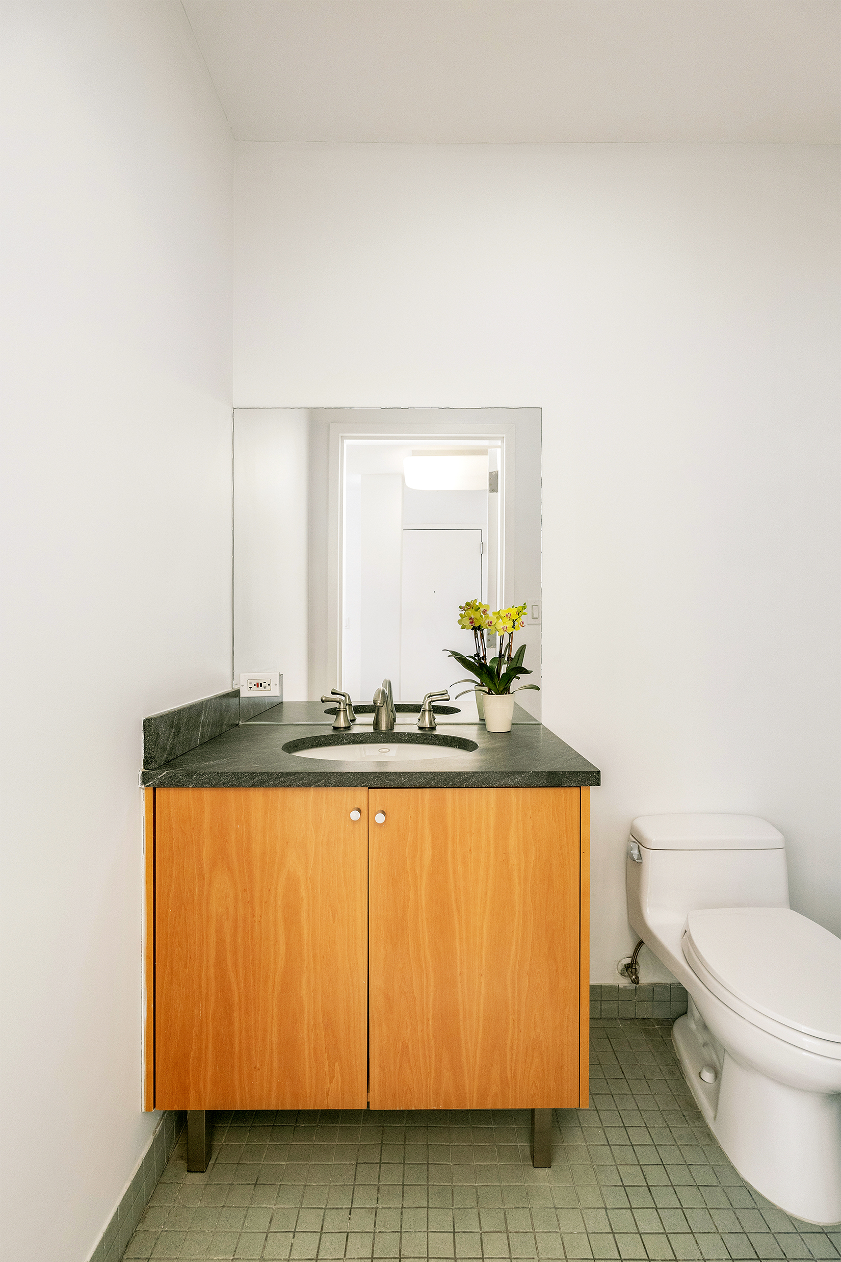26 Broadway, Unit 704 Brooklyn, NY 11249 - Photo 11 of 20 a bathroom with a sink a toilet and mirror