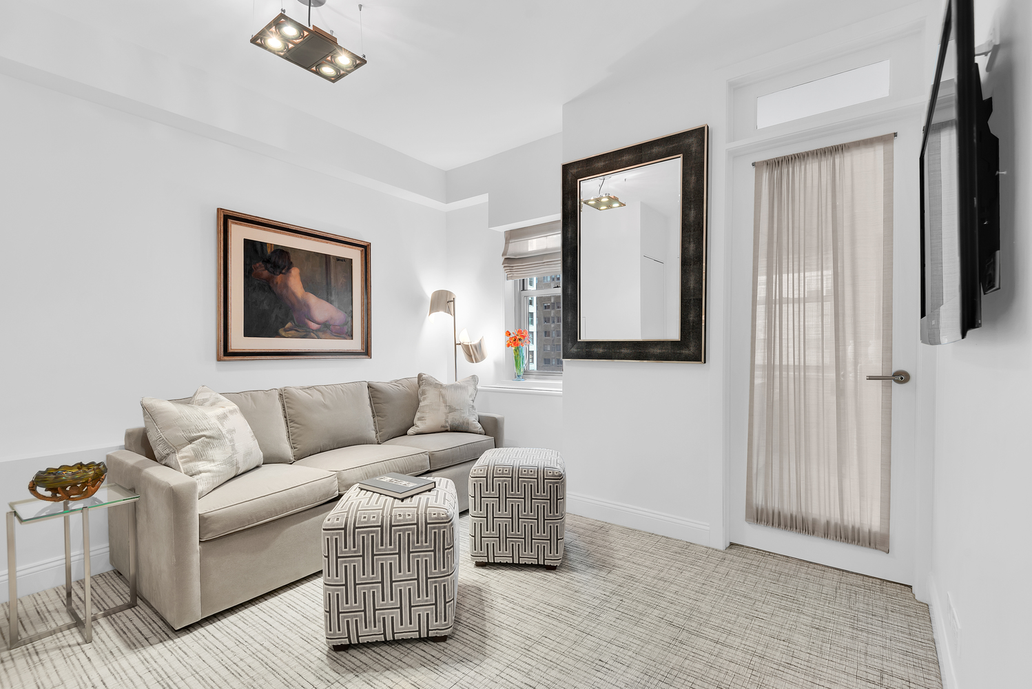 150 East 69th Street, Unit 8J Manhattan, NY 10021 - Photo 7 of 13 a living room with furniture and a painting on the wall