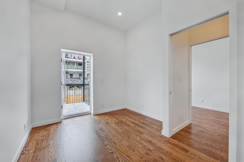 109 President Street, Unit 2 Brooklyn, NY 11231 - Photo 17 of 20 a view of an empty room with wooden floor and a window