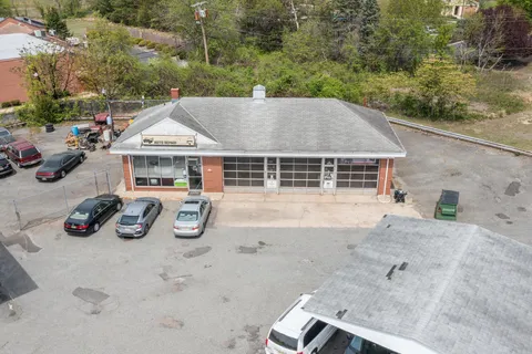 an aerial view of a swimming pool with outdoor seating