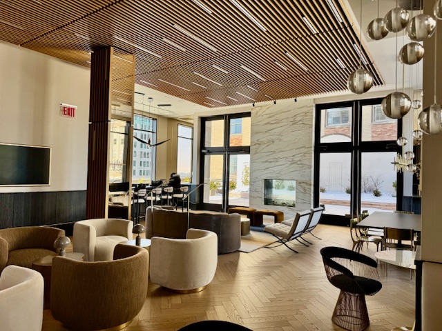 40 Broad Street, Unit 25C Manhattan, NY 10004 - Photo 7 of 10 a living room with furniture and floor to ceiling windows