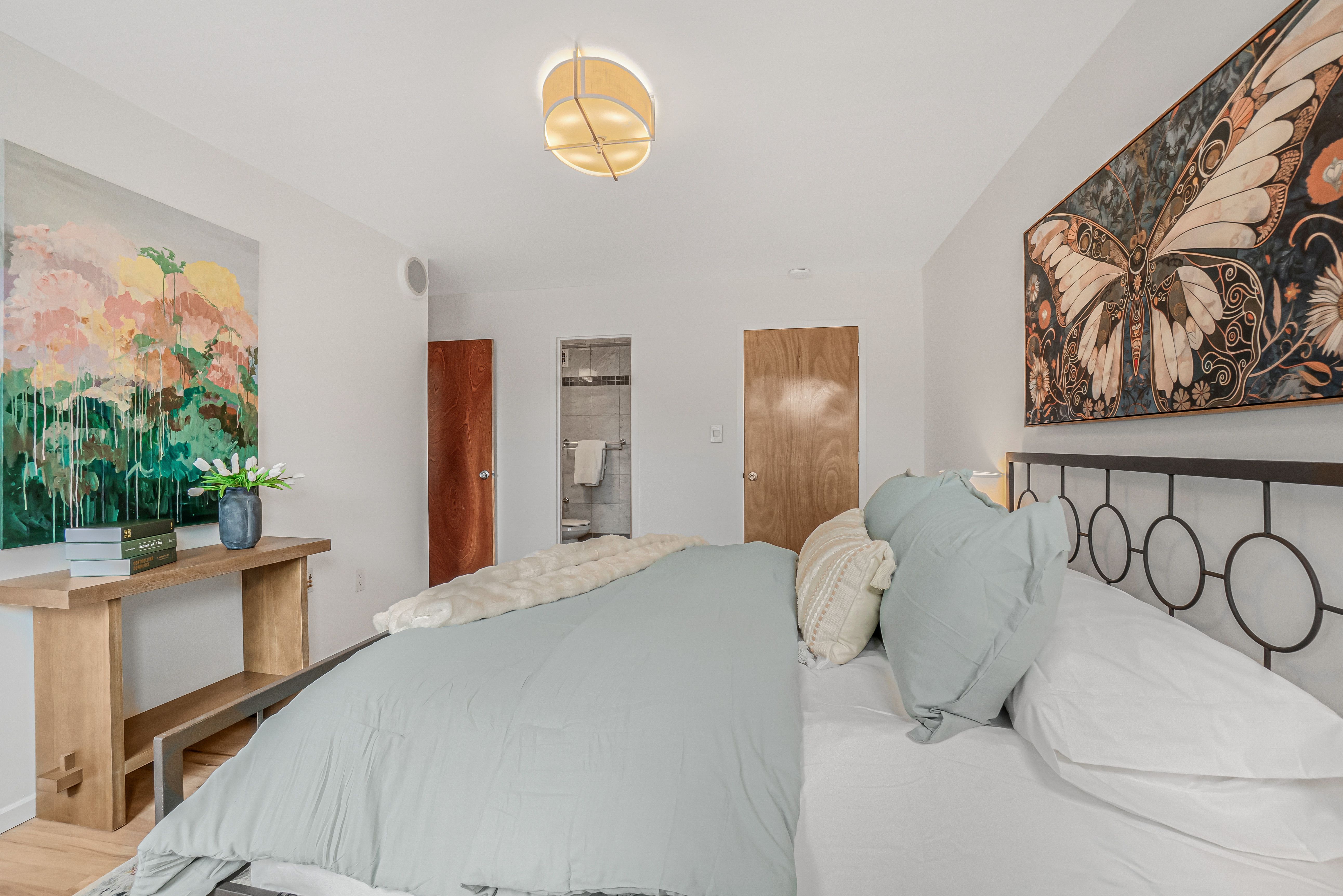 7 Gates Avenue, Unit H Brooklyn, NY 11238 - Photo 14 of 20 a bedroom with a bed and a painting on the wall