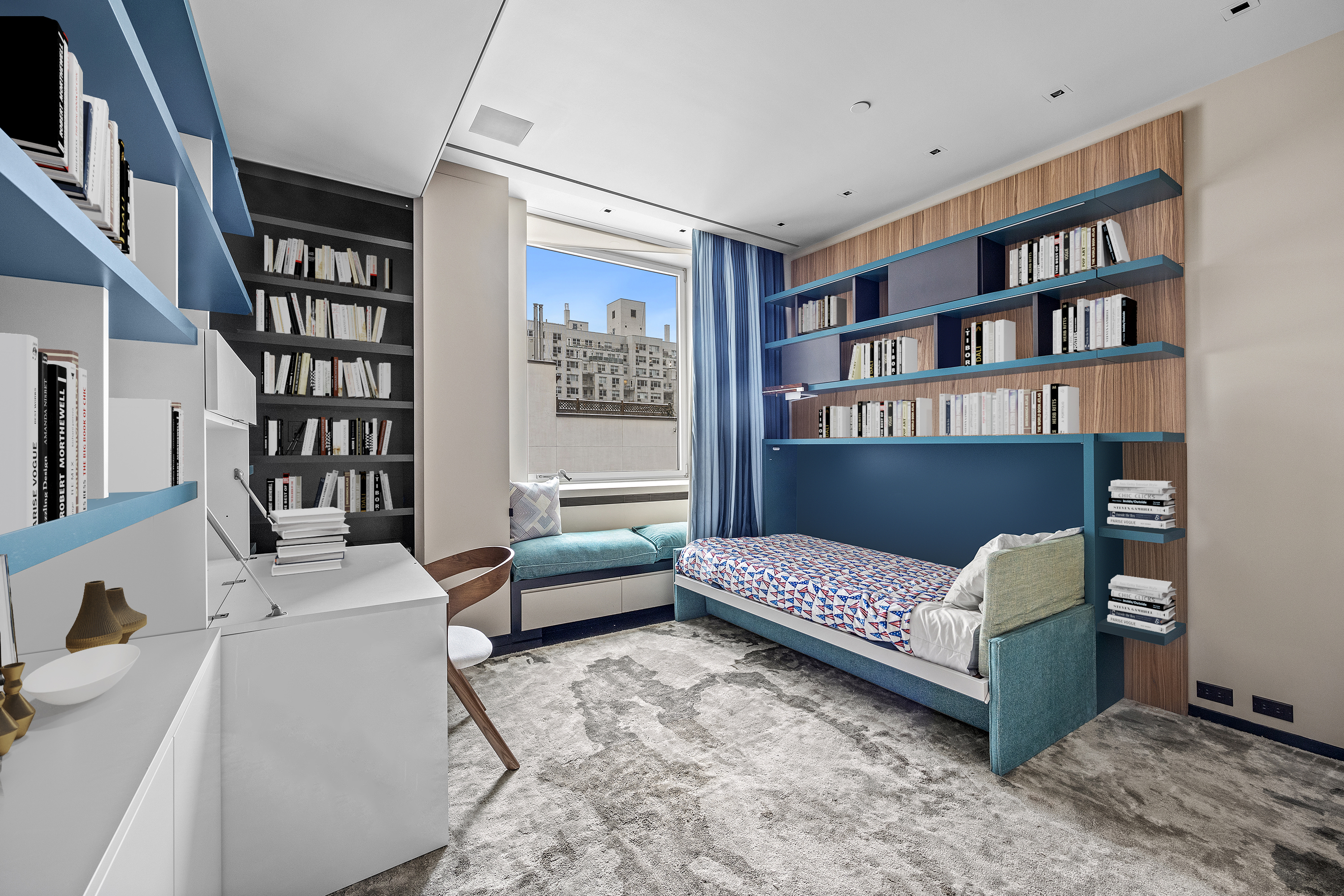219 East 67th Street, Unit 5 Manhattan, NY 10065 - Photo 12 of 18 a living room with furniture and a book shelf