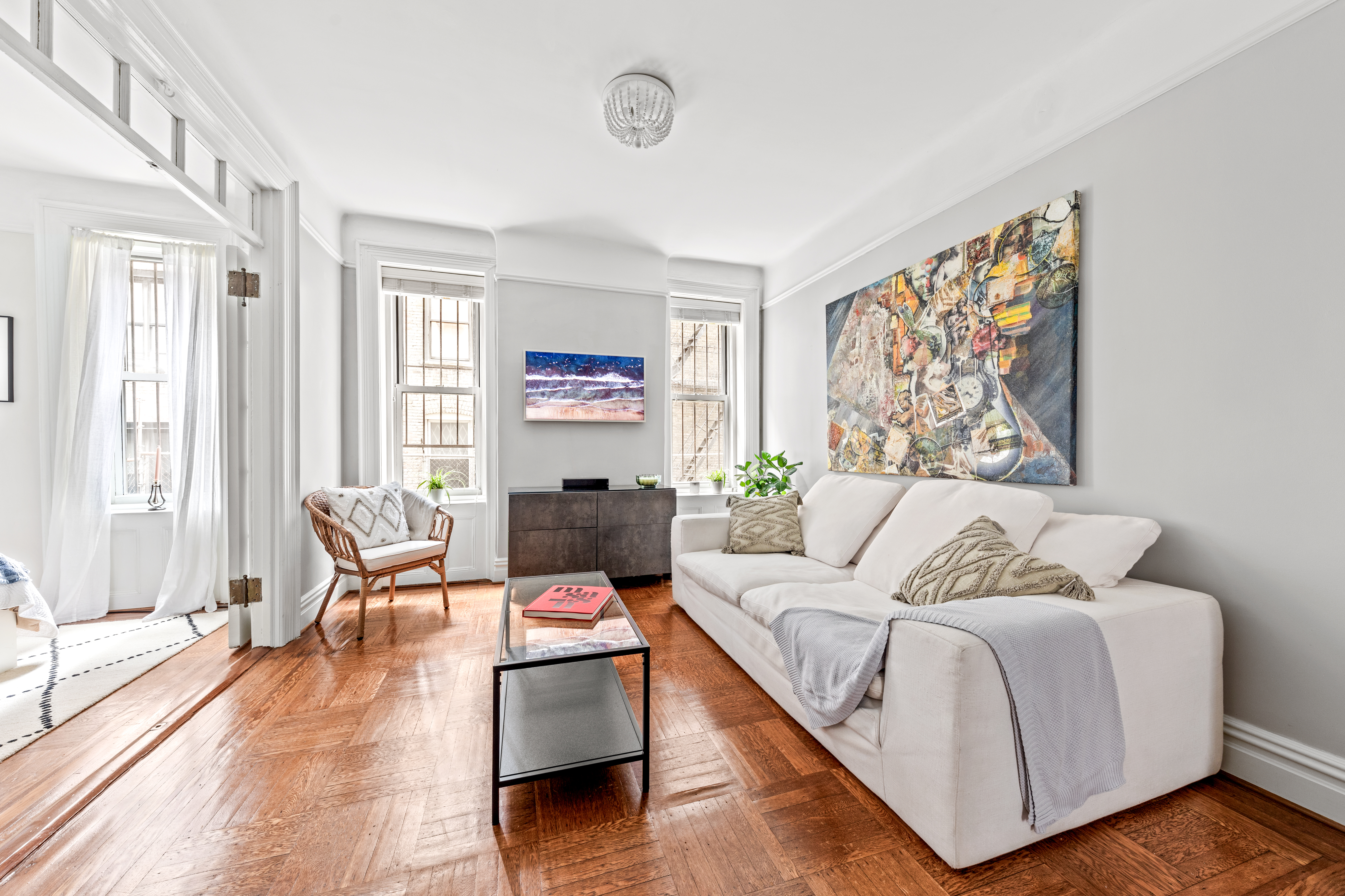 317 West 93rd Street, Unit 1C Manhattan, NY 10025 - Photo 2 of 9 a living room with furniture and large windows