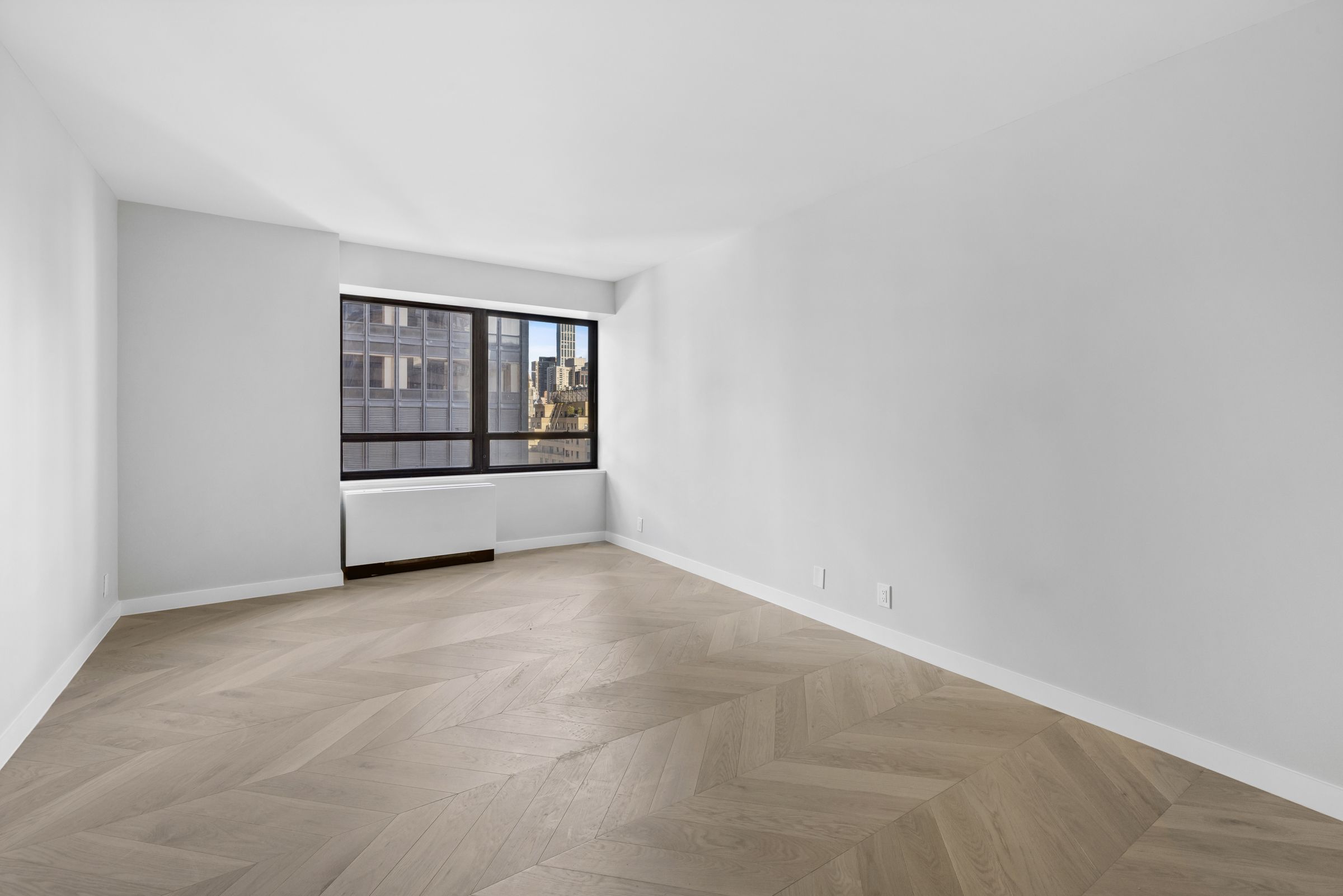 240 East 47th Street, Unit 16CD Manhattan, NY 10017 - Photo 7 of 14 an empty room with a empty space and window