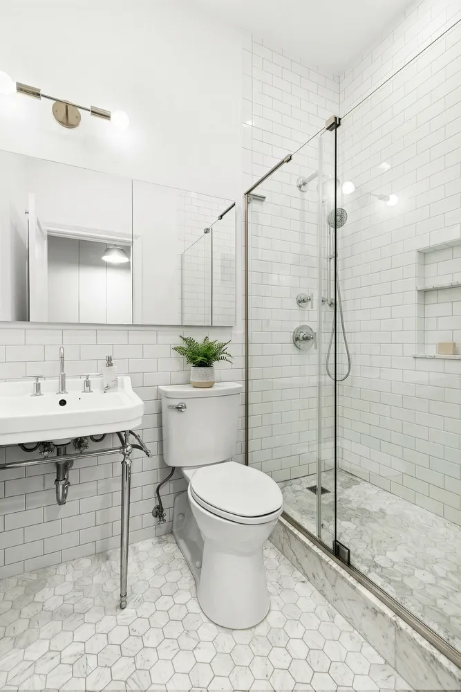 a bathroom with a sink toilet and shower