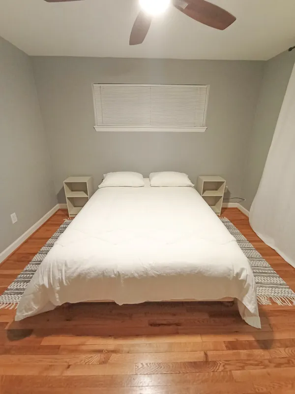 a bedroom with a bed and a night stand