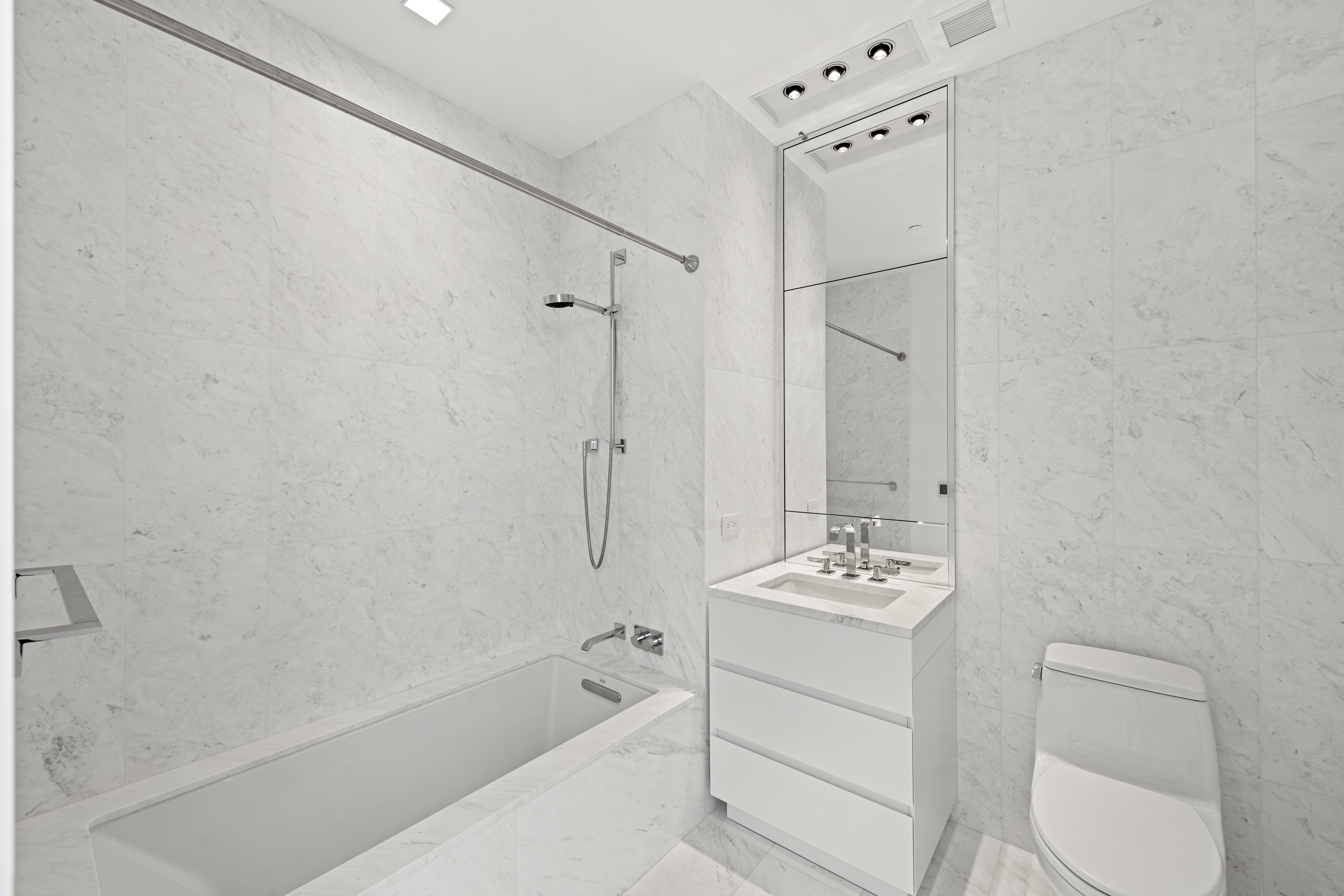 111 Murray Street, Unit 51EAST Manhattan, NY 10007 - Photo 21 of 42 a bathroom with a tub sink and mirror