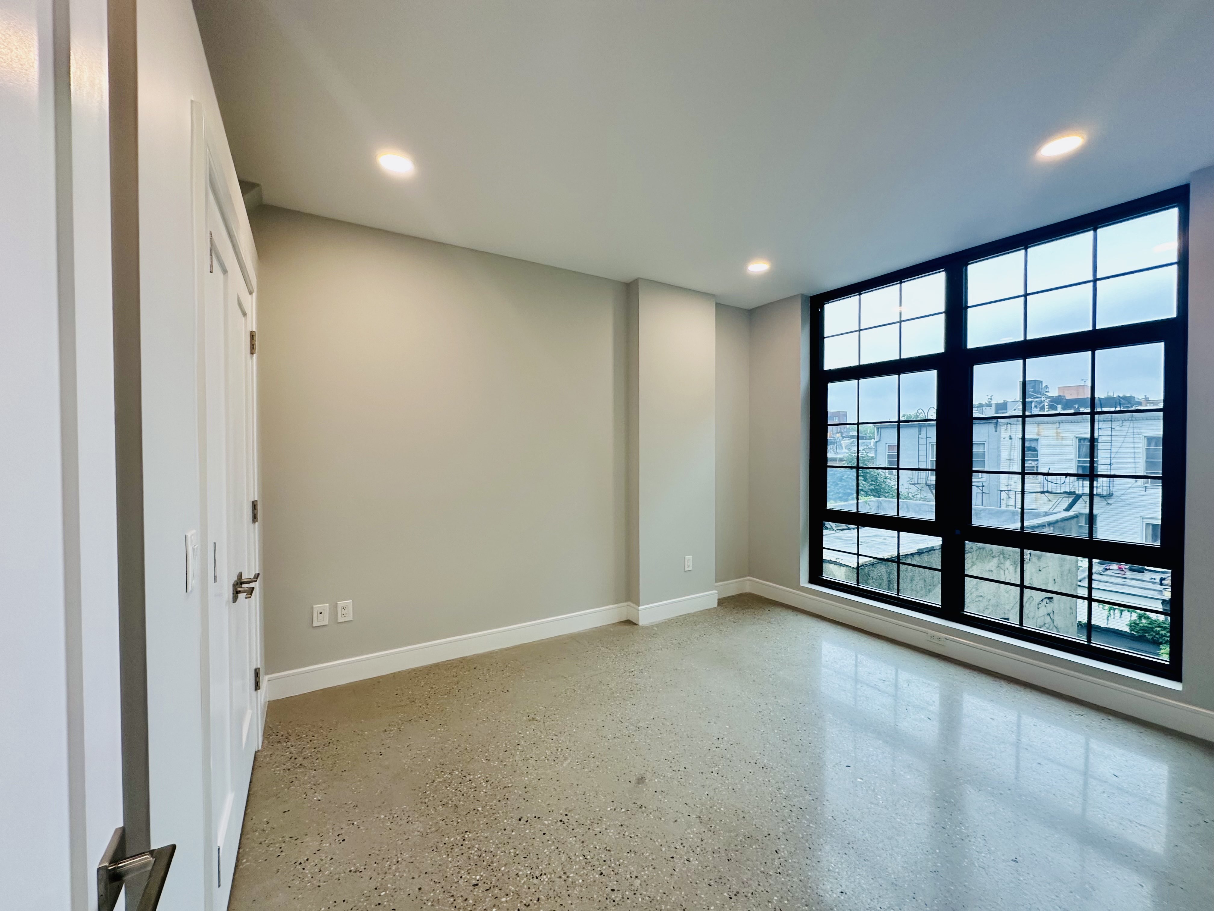 23 Bleecker Street, Unit 4E Brooklyn, NY 11221 - Photo 3 of 11 a view of an empty room with a window