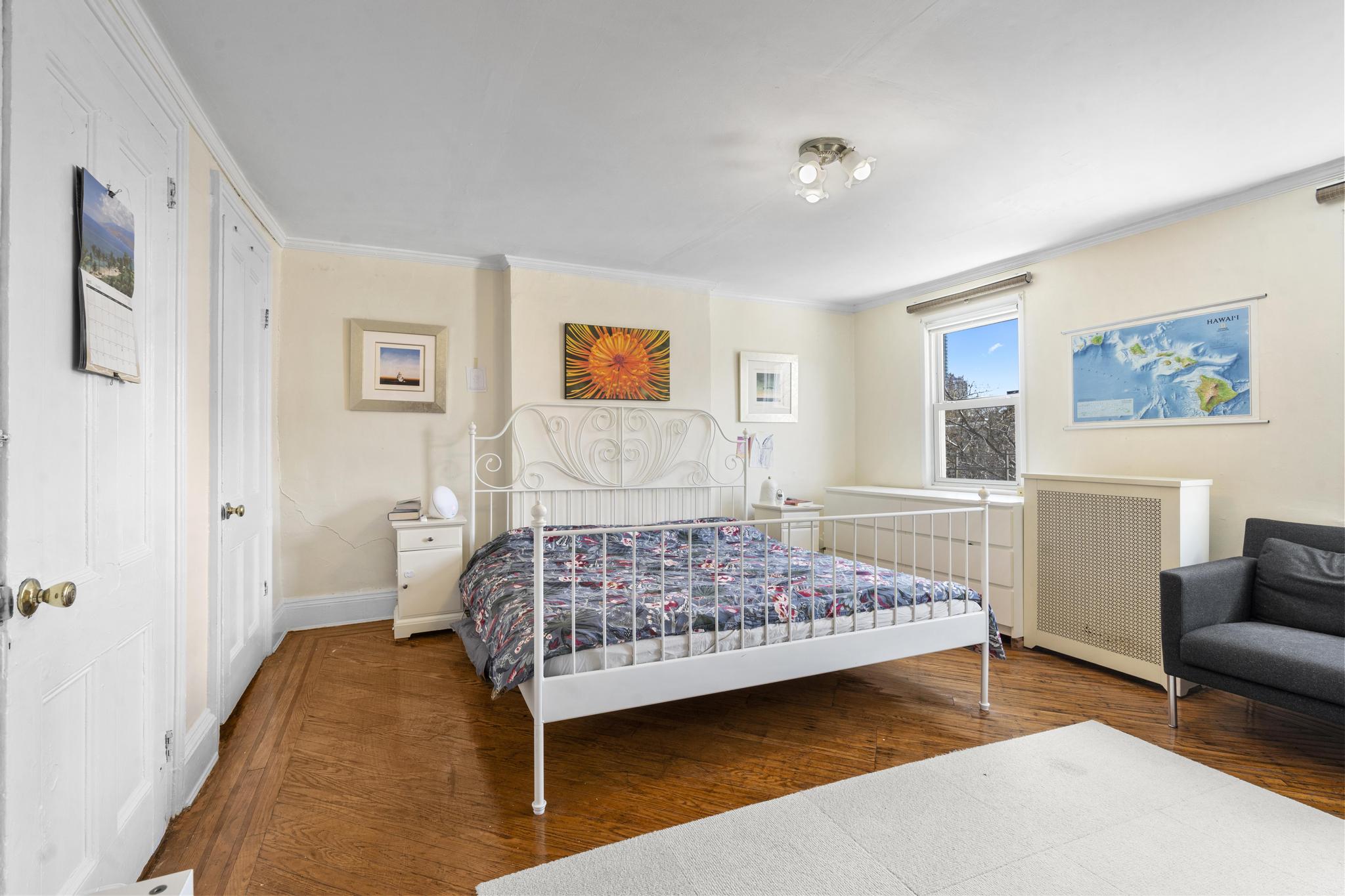 364 Clermont Avenue Brooklyn, NY 11238 - Photo 15 of 18 a bedroom with a bed a couch and a window