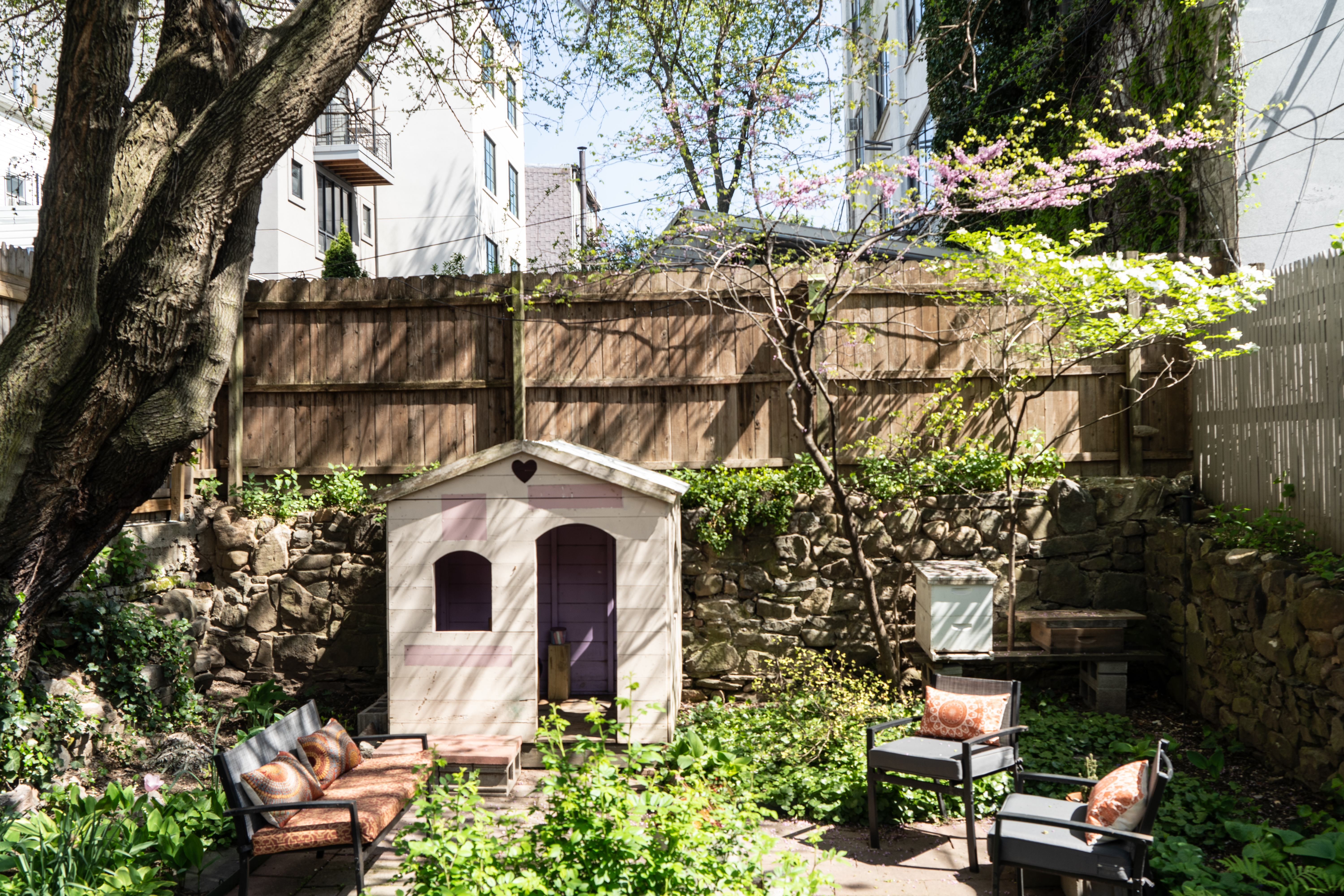 248 17th Street, Unit 6 Brooklyn, NY 11215 - Photo 4 of 21 a backyard of a house with table and chairs and a fire pit