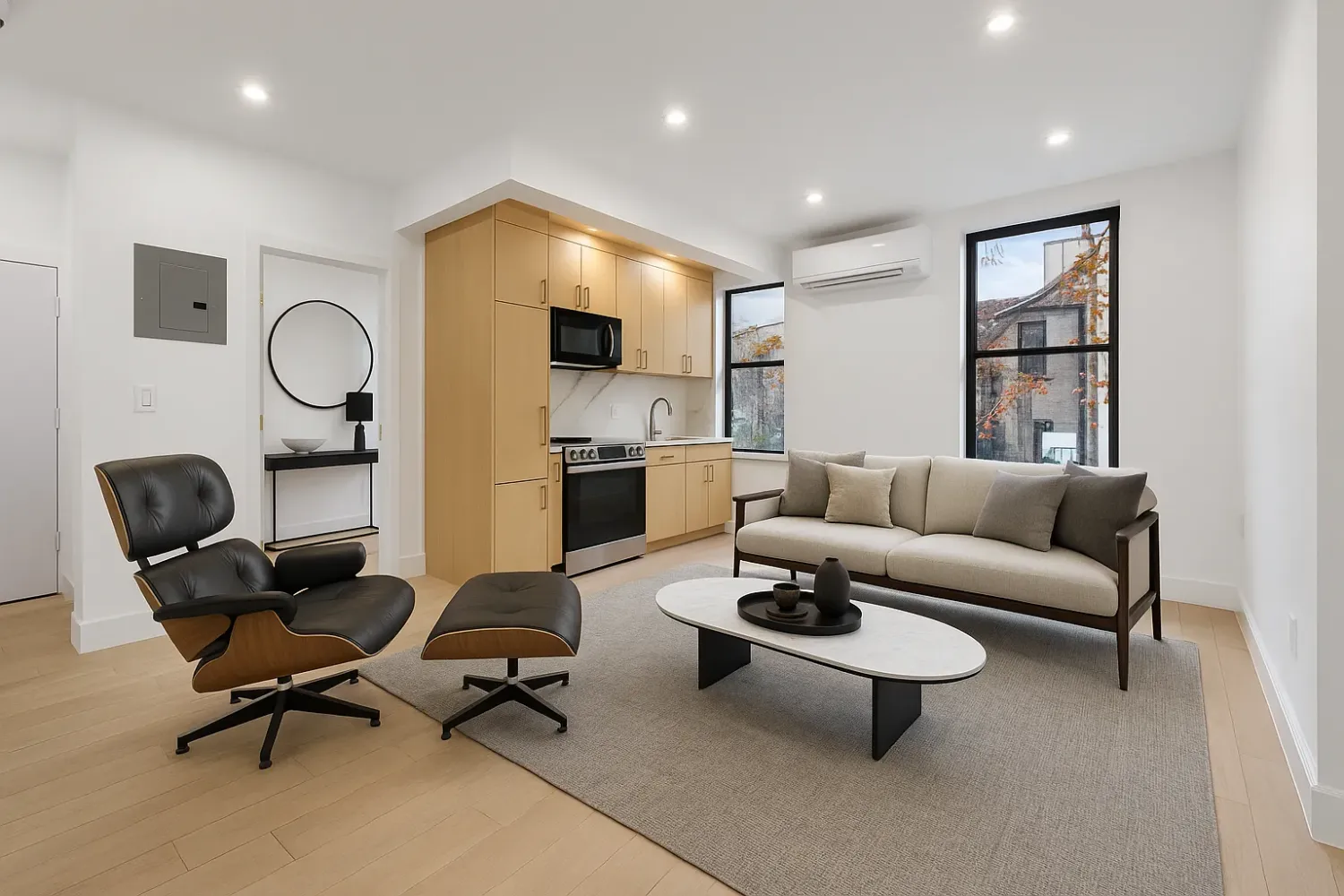 a living room with furniture a rug and white walls