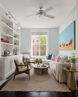 a view of living room with furniture and wooden floor