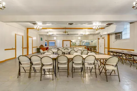 a dinning table with chairs and chandelier
