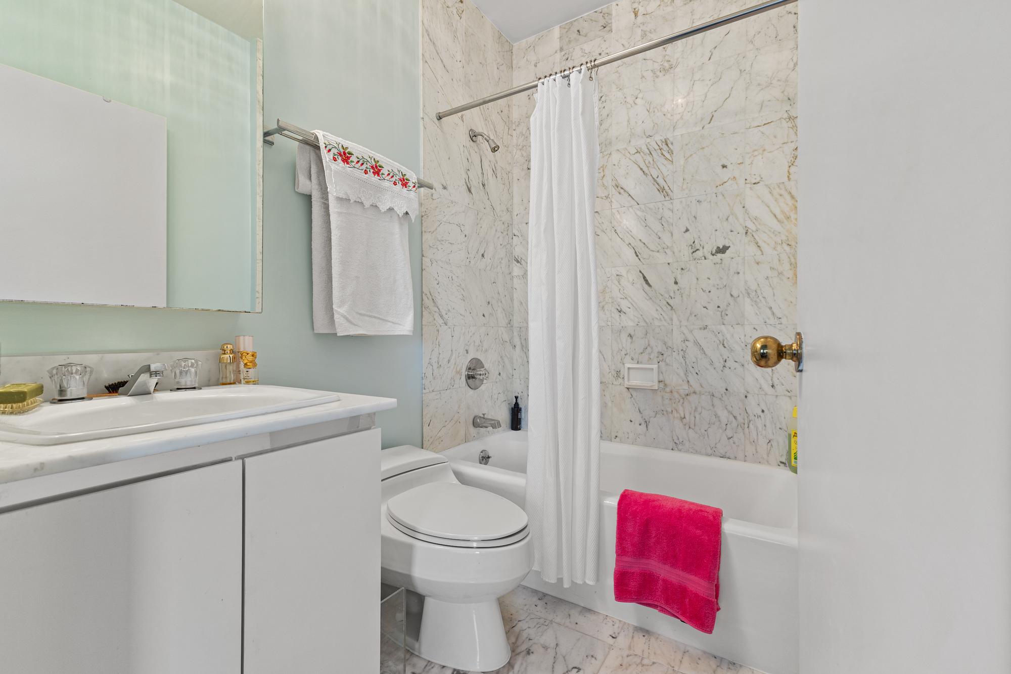 167 East 61st Street, Unit 20E Manhattan, NY 10065 - Photo 19 of 24 a bathroom with a sink toilet and shower