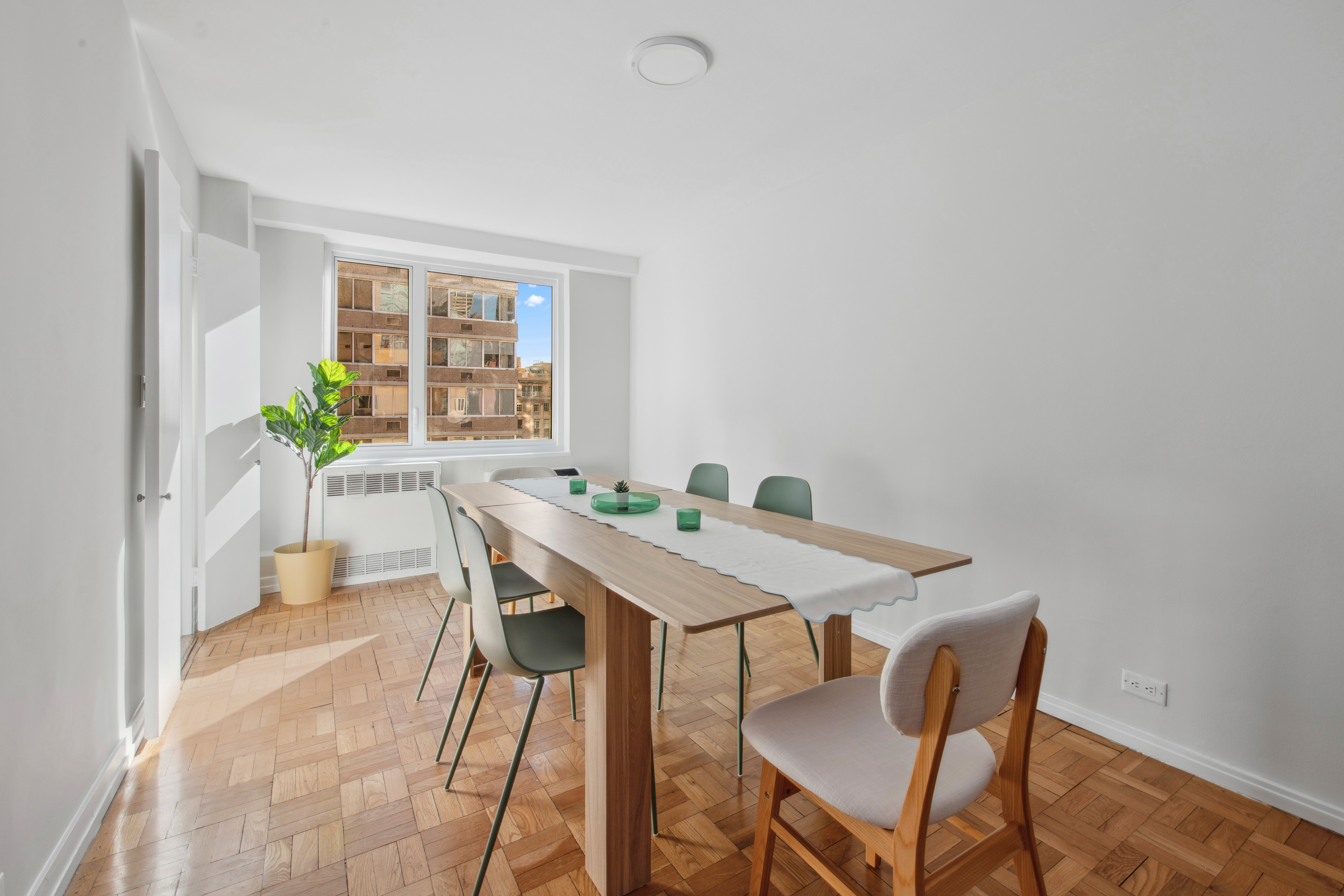 411 East 53rd Street, Unit 20A Manhattan, NY 10022 - Photo 4 of 12 a view of a dining room with furniture and window