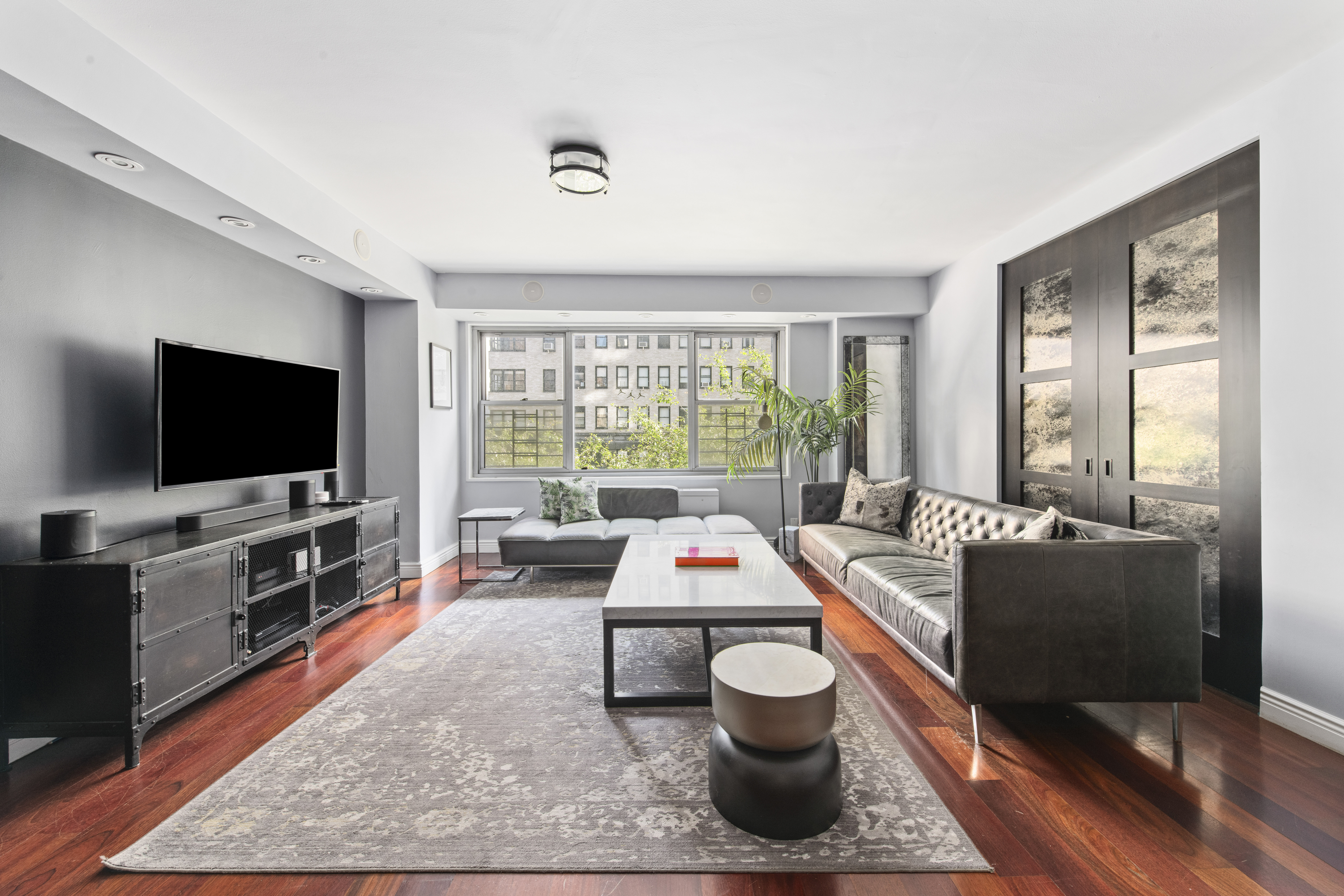 400 East 56th Street, Unit 3D Manhattan, NY 10022 - Photo 2 of 21 a living room with furniture and a flat screen tv