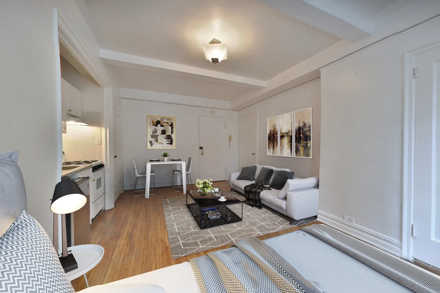 a living room with furniture and wooden floor