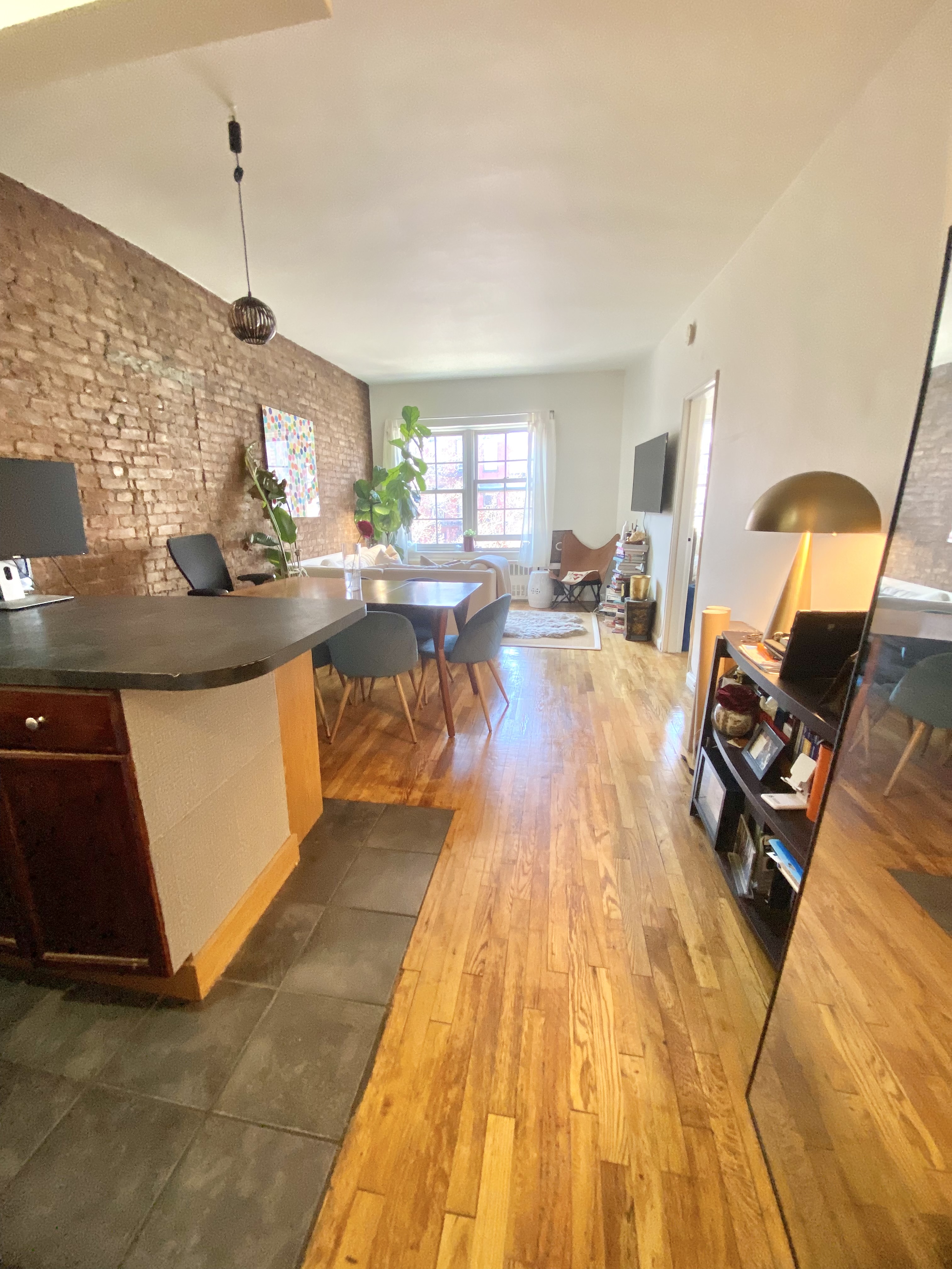 108 Perry Street, Unit 3C Manhattan, NY 10014 - Photo 2 of 6 a living room with furniture and a chandelier