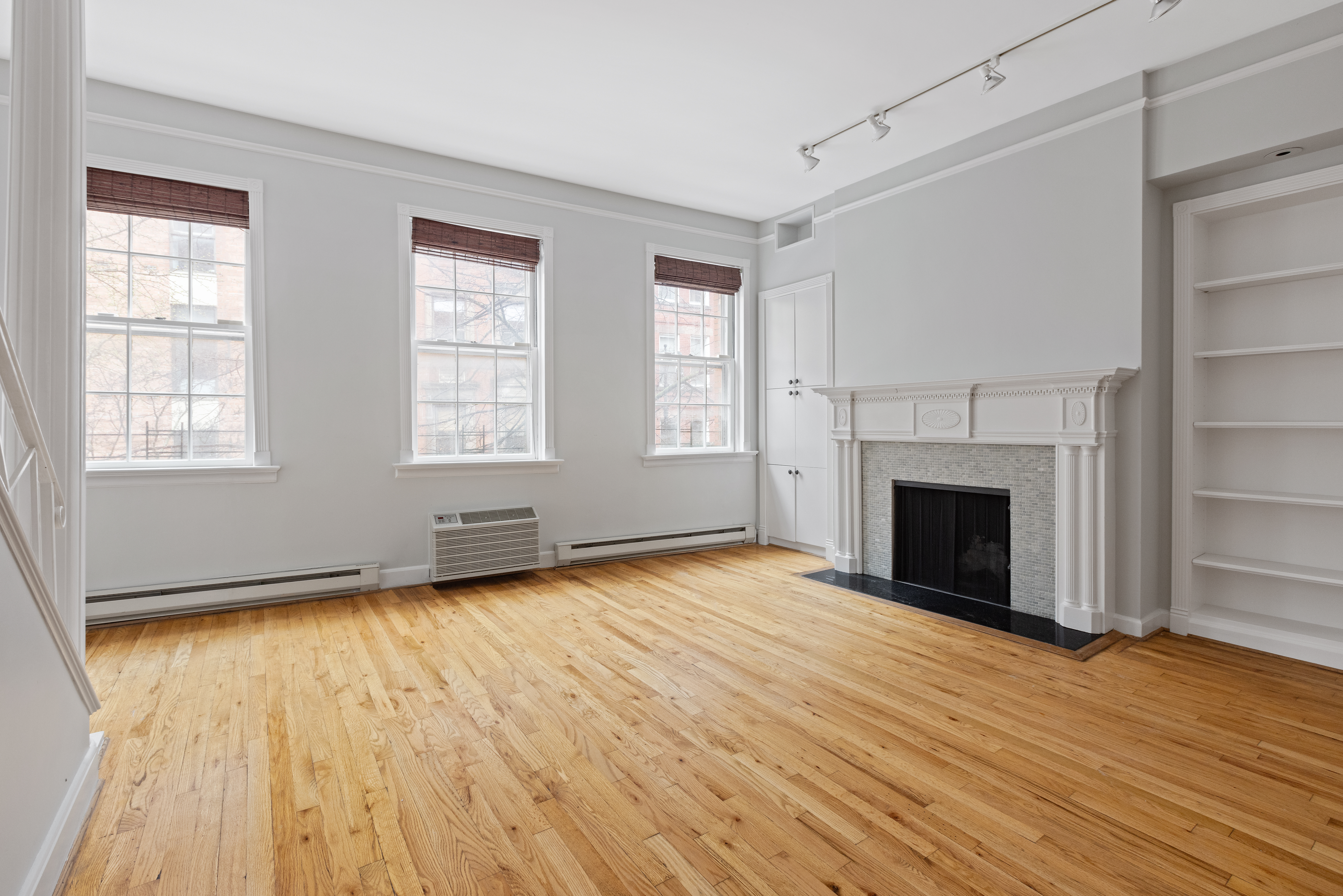 10 Bedford Street Manhattan, NY 10014 - Photo 5 of 29 an empty room with wooden floor fireplace and windows