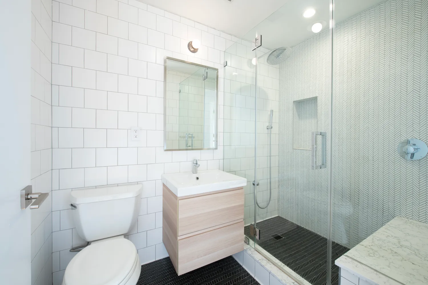 a bathroom with a toilet a sink and mirror