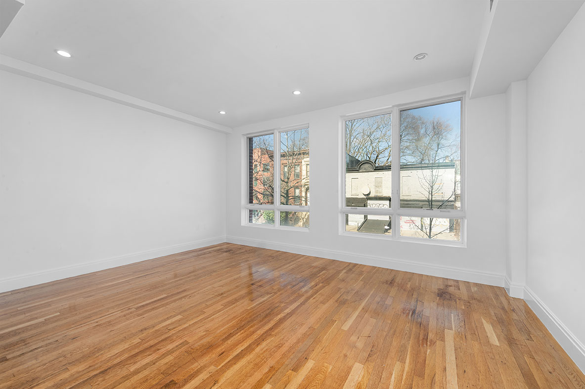 686 MacDonough Street, Unit 2A Brooklyn, NY 11233 - Photo 3 of 8 a view of an empty room with wooden floor and a window