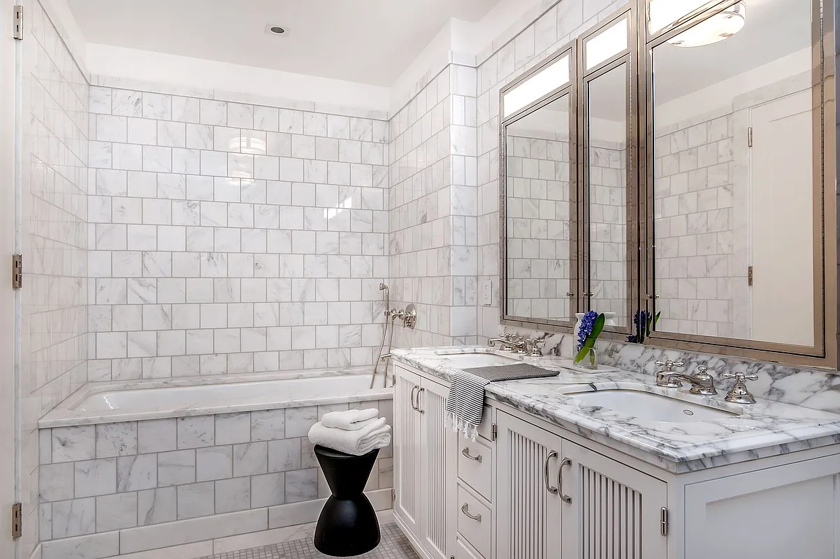 160 West 12th Street, Unit 26 Manhattan, NY 10011 - Photo 5 of 10 a bathroom with a granite countertop sink a toilet a mirror and shower